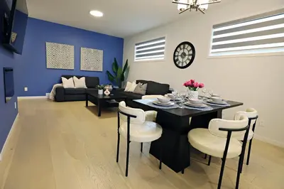 a dining room and living room with a table and chairs at Seton 4BR Family Home 5 Min to South Campus in Calgary