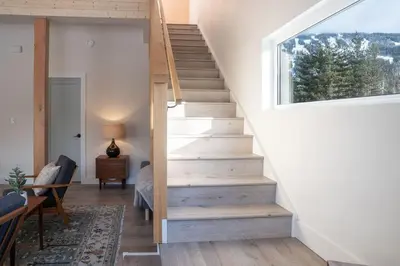 a staircase in a house with a window at CAPOW House in Revelstoke