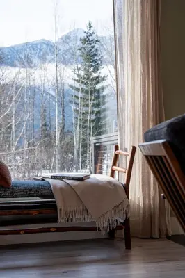a bed in a room with a large window at CAPOW House in Revelstoke