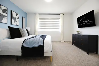 a bedroom with a bed and a dresser and a window at Kinglet 4BR Getaway AC Garage Near WEM DisneyPlus in Edmonton