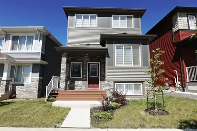 a house with a red door in front of it at Kinglet 4BR Getaway AC Garage Near WEM DisneyPlus in Edmonton