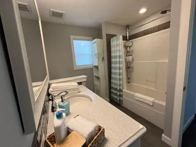 a bathroom with a sink and a shower at The Hidden Gem in Airdrie