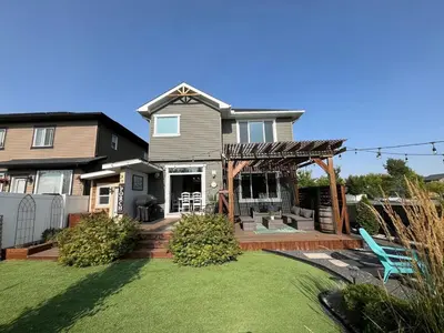a house with a large yard with a gazebo at The Hidden Gem in Airdrie