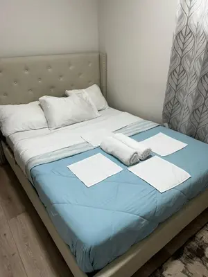a bed with two pillows on top of it at Bedroom in the basement Upland 2 in Edmonton