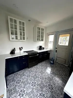 a kitchen with black and white tiles on the floor at The Algonquin Residence in Prince Rupert
