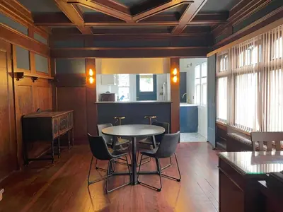 a dining room with a table and chairs at The Algonquin Residence in Prince Rupert