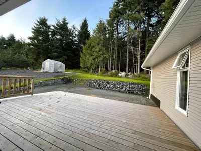 a wooden deck next to a house with a tent at 3 BR Serene Forest Sanctuary in Port Edward