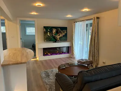 a living room with a couch and a fireplace at 2BR Seaside Haven Retreat