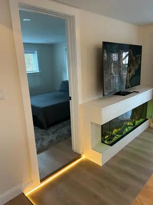 a living room with a fireplace and a bedroom at 2BR Seaside Haven Retreat