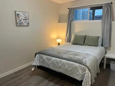 a small bedroom with a bed with a window at 3 Adjacent 4-bed Homes - Park Views, Fully Stocked in Grande Prairie