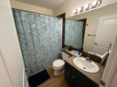 a bathroom with a sink and a toilet and a shower at 3 Adjacent 4-bed Homes - Park Views, Fully Stocked in Grande Prairie