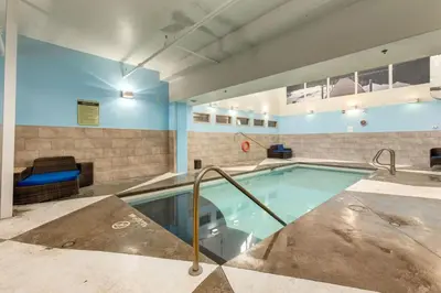 a swimming pool in a building with a pool at Mountain Escape 2BR Hot tub and Pool Near Banff in Canmore
