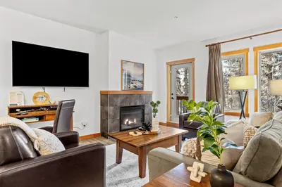 a living room with a couch and a fireplace at 3BR Family Friendly Getaway Pool and Hot Tub in Canmore
