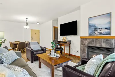 a living room with a fireplace and a tv at 3BR Family Friendly Getaway Pool and Hot Tub in Canmore