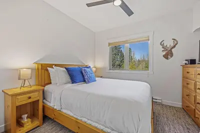 a bedroom with a bed and a window at Spacious 2BR Minutes from Downtown w Pool and Hot Tub in Canmore