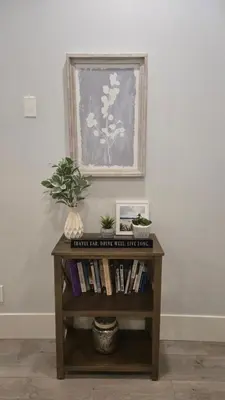 a book shelf with books and a picture on the wall at 2BR Suite Close to Transit - Great for FIFA Vancouver in Burnaby