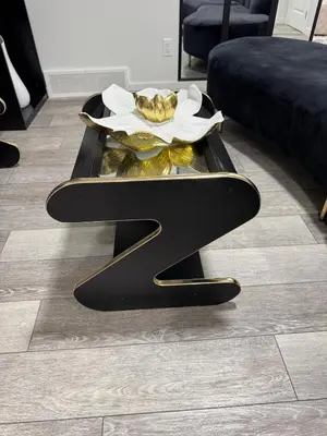 a black coffee table with a plate of food on it at Luxury Haven by Kc & Flo in Calgary