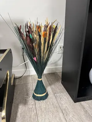 a green vase filled with dried grass at Luxury Haven by Kc & Flo in Calgary