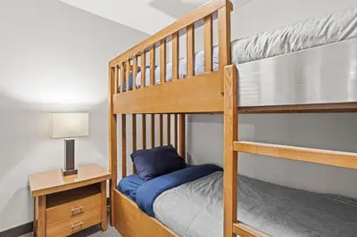 a bedroom with two bunk beds with a blue pillow at Cozy Oasis 2BR with Hot Tub and Gym 10 Mins to DT in Dead Man's Flats