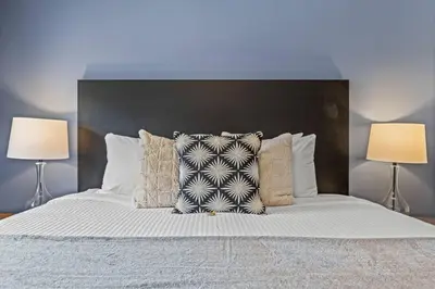 a bedroom with a bed with two lamps on it at Amazing 3BR Condo With Hot Tub Access and Mtn Views in Dead Man's Flats