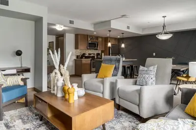 a living room with two couches and a table at Lovely 3BR condo with Hot Tub at the Edge of Canmore in Dead Man's Flats