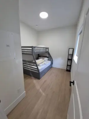 a small bedroom with a bunk bed in a room at Sunny Skies Suites in Surrey
