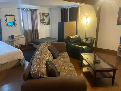 a living room with a couch and a bed at Large Farm in Bélanger