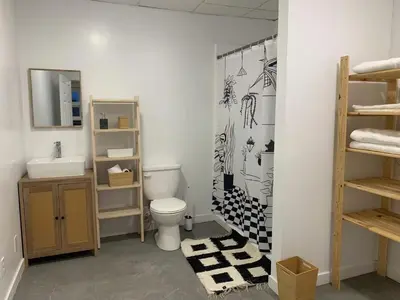 a bathroom with a toilet and a sink at ArtHaus Downtown Jim Robb Unit 3BR 3BA in Whitehorse