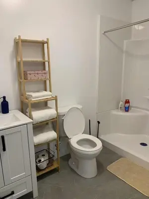 a bathroom with a toilet and a sink and a bath tub at ArtHaus Downtown Jim Robb Unit 3BR 3BA in Whitehorse