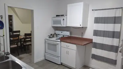 a small kitchen with a stove and a microwave at 347 Des Meurons Street Unit A and Unit B in Bélanger