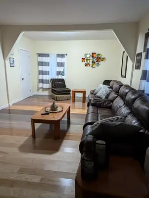 a living room with a leather couch and a coffee table at 347 Des Meurons Street Unit A and Unit B in Bélanger