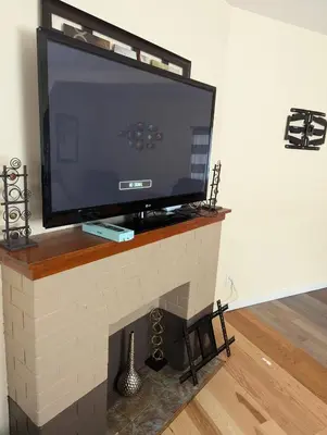 a flat screen tv sitting on top of a fireplace at 347 Des Meurons Street Unit A and Unit B in Bélanger