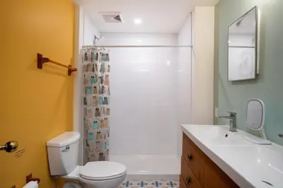 a bathroom with a toilet and a sink and a shower at The Mushroom Manor B&B and Cedar Sauna in Salt Spring Island