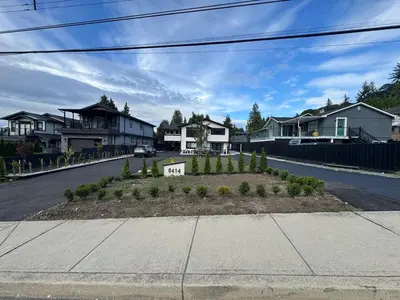 a residential street with houses and a driveway at Ricky's Apartment in Delta