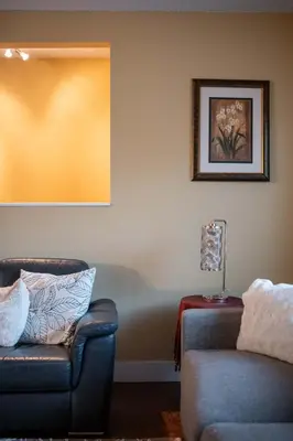a living room with two chairs and a lamp at Cozy 3BR Family Home near City Centre & SkyTrain in Coquitlam