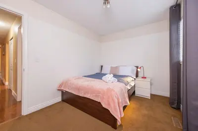 a bedroom with a bed with a teddy bear on it at Cozy 3BR Family Home near City Centre & SkyTrain in Coquitlam