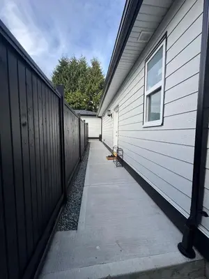 a walkway next to a house with a fence at Brand new fully private Garden Suite 1 in Delta