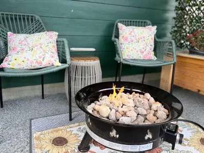 a grill with food in it on a table with chairs at A Room of One's Own-A perfect getaway by the sea in North Nanaimo in Nanaimo