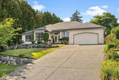 a house with a garage and a driveway at Surrey Nature Retreat 4BDR Home in Surrey