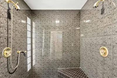 a bathroom with a shower with a bench in it at Surrey Nature Retreat 4BDR Home in Surrey