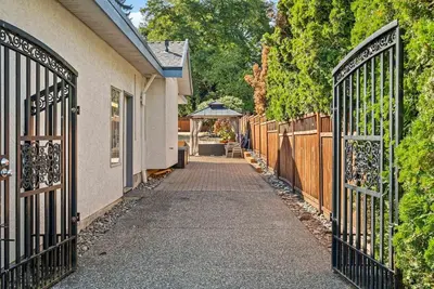 an entrance to a house with a gate at Surrey Nature Retreat 4BDR Home in Surrey