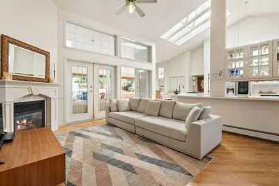 a living room with a couch and a fireplace at Surrey Nature Retreat 4BDR Home in Surrey