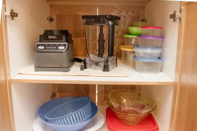 a kitchen organizer with a blender and other kitchen items at Cozy Canmore 2-Bedroom Retreat in Canmore