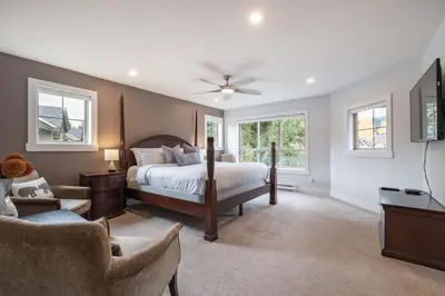 a bedroom with a bed and a tv and a couch at Englewood Greens 40 by Outpost Whistler in Whistler
