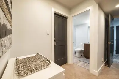a bathroom with a toilet and a bed with a pillow at Englewood Greens 40 by Outpost Whistler in Whistler