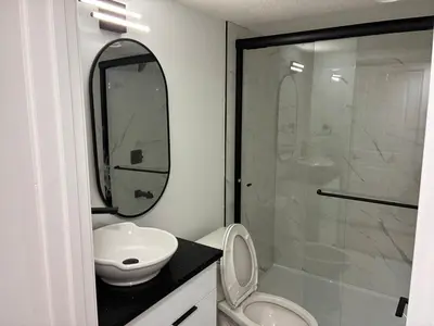 a bathroom with a toilet and a sink and a shower at Home away from Home in Edmonton