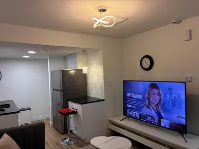 a living room with a large flat screen tv at Home away from Home in Edmonton