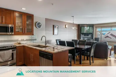 a kitchen and dining room with a table and chairs at Raven's Nest - Mtn View & Hot Tub sleeps 6 in Carmi