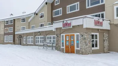 a hotel building with snow in front of it at Raven's Nest - Mtn View & Hot Tub sleeps 6 in Carmi