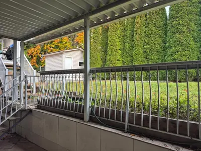 a screened porch with a fence and a yard at Enjoy Life in Heart of North Delta in Delta